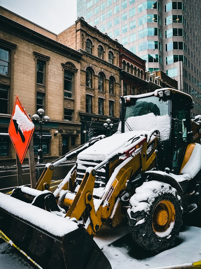 pexels photo 14825337 A snow-covered tractor excavator on a Toronto city street during winter roadworks.